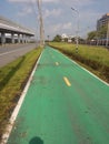 Green way near motorway in clear sky. Royalty Free Stock Photo