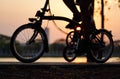 Bike wheels close up image on asphalt sunset road Royalty Free Stock Photo