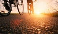 Bike wheels close up image on asphalt sunset road