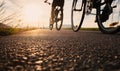 Bike wheels close up image on asphalt sunset road Royalty Free Stock Photo