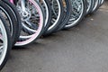 Bike wheels in a row, bikes for rent - diagonal composition