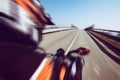 Biker in action riding on the road spring and summer outdoors leisure season and freedom conceptt- toned with a trendy filter Royalty Free Stock Photo