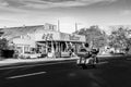 Biker arrives while morning shade still covers street in Seligman, Arizona, USA Royalty Free Stock Photo