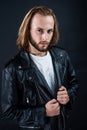 biker. bearded rocker in leather jacket. man with long hair. rock style fashion. Royalty Free Stock Photo