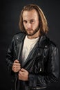 biker. bearded rocker in leather jacket. man with long hair. rock style fashion. Royalty Free Stock Photo