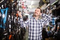 Biker is choosing in sports store convenient bike