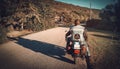 Biker on a classic motrocycle on a country road