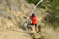 Biker pushing his bike on a hill at an MTB race Royalty Free Stock Photo