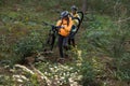 Biker couple carrying their mountain bike and walking in forest Royalty Free Stock Photo