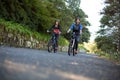 Biker couple cycling on the countryside road Royalty Free Stock Photo