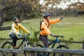 Biker couple cycling and pointing in distance