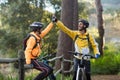 Biker couple giving high five to each other in countryside Royalty Free Stock Photo