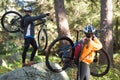 Biker couple holding their mountain bike and pointing at distance Royalty Free Stock Photo