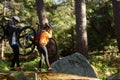 Biker couple holding their mountain bike and walking in forest Royalty Free Stock Photo