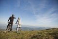 Biker couple with mountain bike pointing in distance at countryside Royalty Free Stock Photo