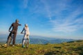 Biker couple with mountain bike pointing in distance at countryside Royalty Free Stock Photo