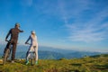 Biker couple with mountain bike pointing in distance at countryside Royalty Free Stock Photo