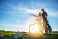 Biker couple with mountain bike pointing in distance at countryside Royalty Free Stock Photo