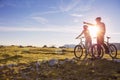 Biker couple with mountain bike pointing in distance at countryside Royalty Free Stock Photo