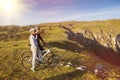 Biker couple with mountain bike pointing in distance at countryside Royalty Free Stock Photo