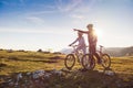 Biker couple with mountain bike pointing in distance at countryside Royalty Free Stock Photo