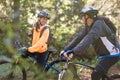 Biker couple riding mountain bike in the forest Royalty Free Stock Photo