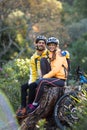 Biker couple sitting on a tree stump