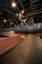 Biker doing bar spin drop trick Royalty Free Stock Photo