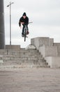 Biker doing bar spin trick Royalty Free Stock Photo