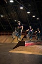 Biker doing manual to bar spin trick Royalty Free Stock Photo