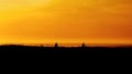 Biker family silhouette having fun on the beach at the sunset time. Concept of friendly family and of summer vacation Royalty Free Stock Photo