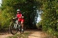 Biker on the forest road riding outdoor