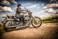 Biker girl and bike Harley Sportster Royalty Free Stock Photo