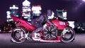 Biker girl with helmet riding a sci-fi bike, woman on red futuristic motorcycle in night city street, side view, 3D render Royalty Free Stock Photo