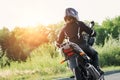 Biker girl in a leather jacket and helmet on a motorcycle Royalty Free Stock Photo