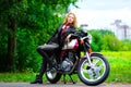 Biker girl in leather jacket on a motorcycle