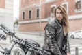 Biker girl in a leather jacket on a motorcycle Royalty Free Stock Photo