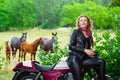 Biker girl in leather jacket on a motorcycle over