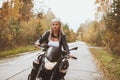 Biker girl rides a motorcycle in the rain. First-person view Royalty Free Stock Photo