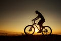 Biker-girl at the sunset on mountains Royalty Free Stock Photo