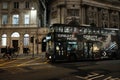 A biker going toward a cool looking bus in central London, Uk