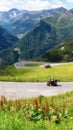 Biker on Grossglockner High Alpine Road, scenic tourist route in Austrian Alps Royalty Free Stock Photo