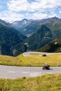 Biker on Grossglockner High Alpine Road, scenic tourist route in Austrian Alps Royalty Free Stock Photo