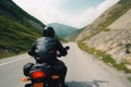 A biker in a helmet and a black jacket rides a motorcycle on a road in the mountains. Travel in your own vehicle. Generative AI Royalty Free Stock Photo