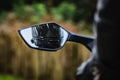 Biker in a helmet reflected in the rearview mirror Royalty Free Stock Photo