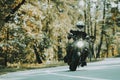 Biker In Helmet Is Riding On Highway In A Forest.