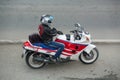 Biker in a helmet sitting on his motorcycle.