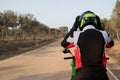 Biker with his equipment, putting on the safety helmet on his motorcycle before traveling. Royalty Free Stock Photo