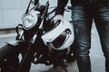 Biker Holds Moto Helmet. Motorcycle On Background.