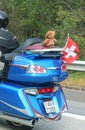 Biker with a large motorcycle decorated with a Swiss lag and a teddy bear